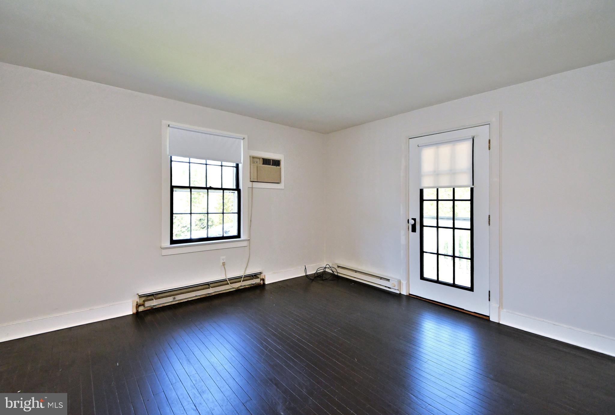 143 Old York Road New Hope, PA 18938 - Photo 25 of 70 an empty room with wooden floor and windows