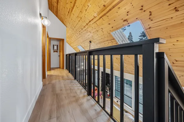 a utility room with a bed and wooden floor