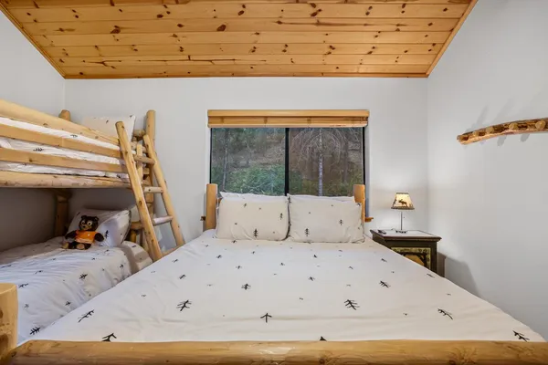 a bed sitting in a bedroom next to a window