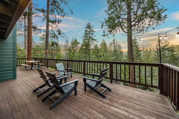 a view of a roof deck with wooden floor and fence