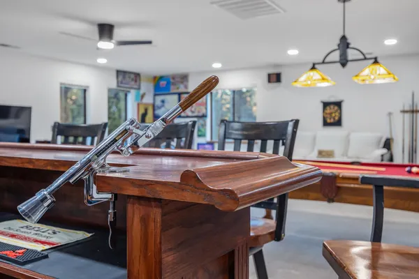 a living room with furniture a ceiling fan and a rug