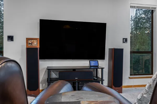 a backyard of a house with barbeque oven table and chairs