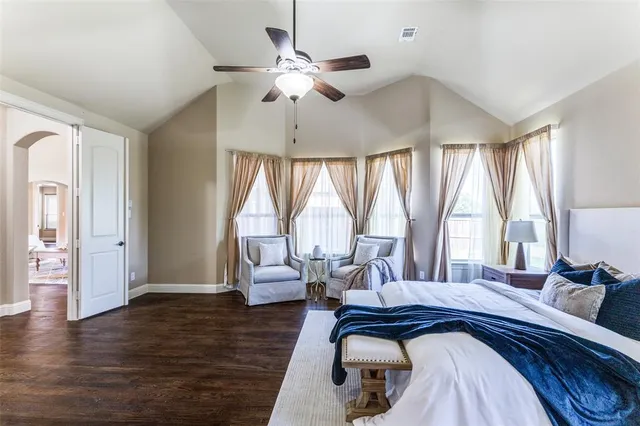 a bedroom with a bed and a large window