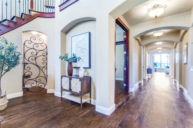 a view of a hallway with wooden floor and staircase