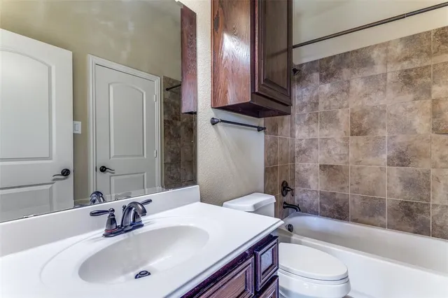 a bathroom with a sink a toilet and a bathtub