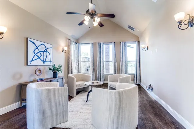 a living room with furniture chandelier and a window