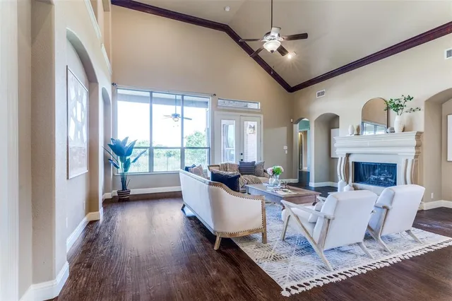 a living room with fireplace furniture and a large window