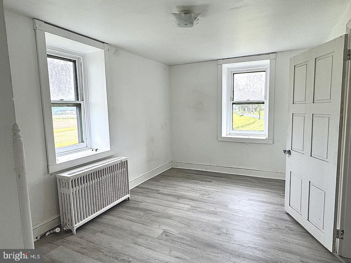 133 Hunter Road Oley, PA 19547 - Photo 16 of 44 an empty room with wooden floor and windows