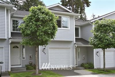 2210 South 336th Street, Unit 404 Federal Way, WA 98003 - Photo 1 of 1 a view of a white house next to a yard