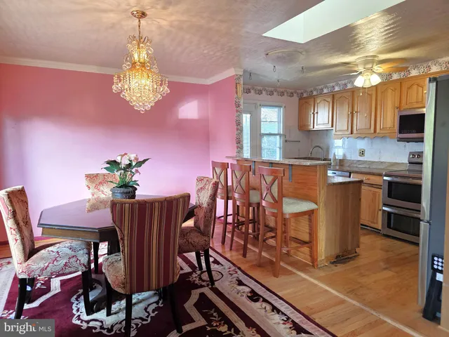 a dining room with furniture and chandelier