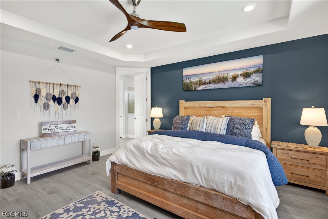 11914 Bourke Place Fort Myers, FL 33913 - Photo 17 of 49 a bedroom with a bed and lamp