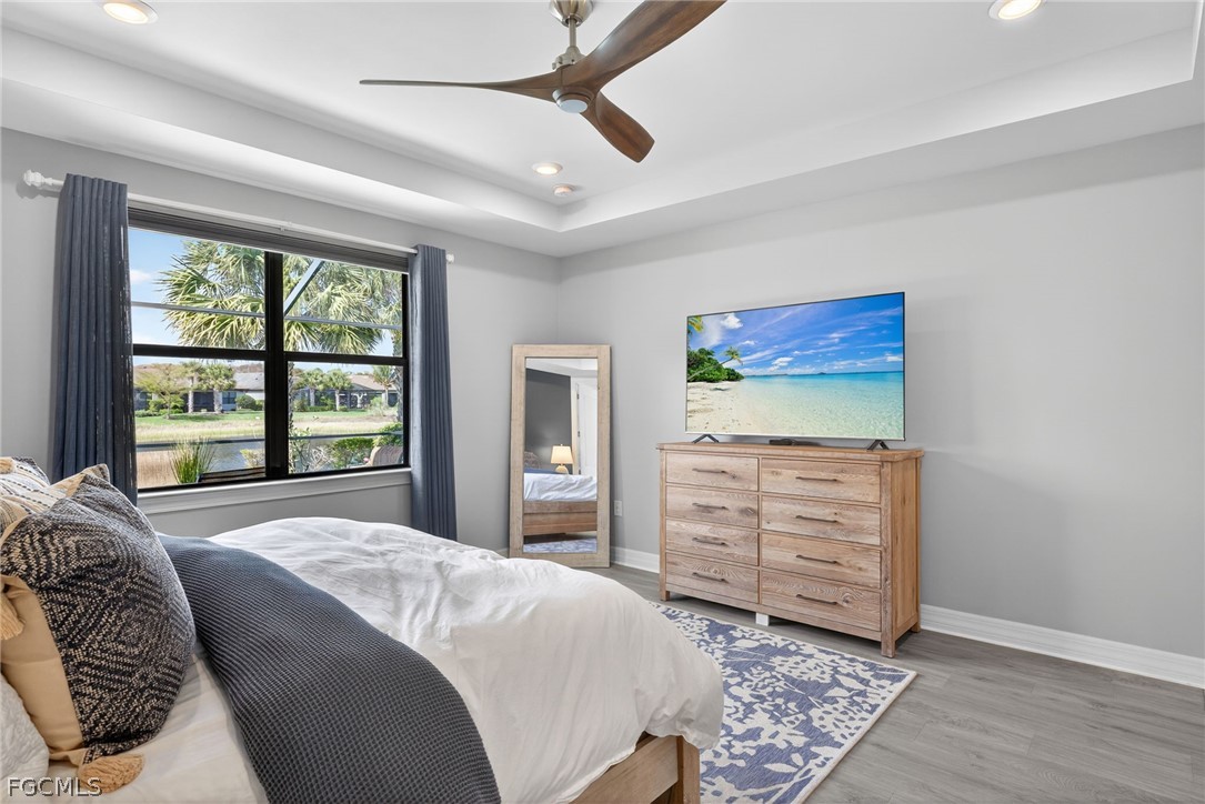 11914 Bourke Place Fort Myers, FL 33913 - Photo 19 of 49 a bedroom with a bed and a dresser