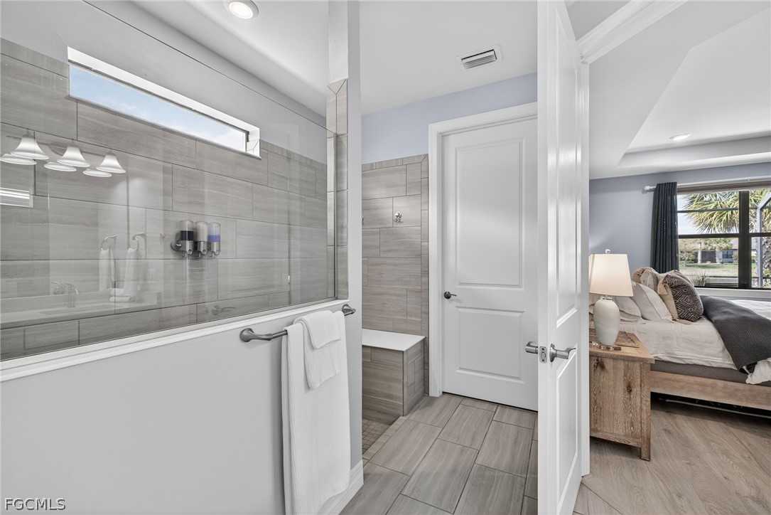 11914 Bourke Place Fort Myers, FL 33913 - Photo 21 of 49 a bathroom with a tub and shower