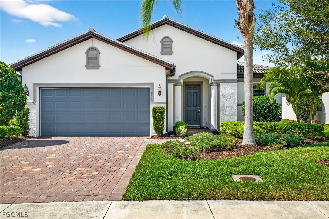 11914 Bourke Place Fort Myers, FL 33913 - Photo 3 of 49 a front view of a house with a yard and garage