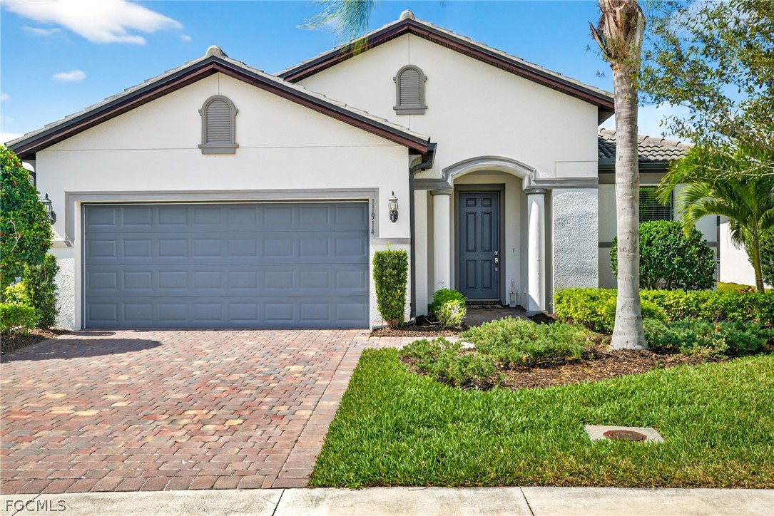 11914 Bourke Place Fort Myers, FL 33913 - Photo 34 of 49 a front view of a house with garden