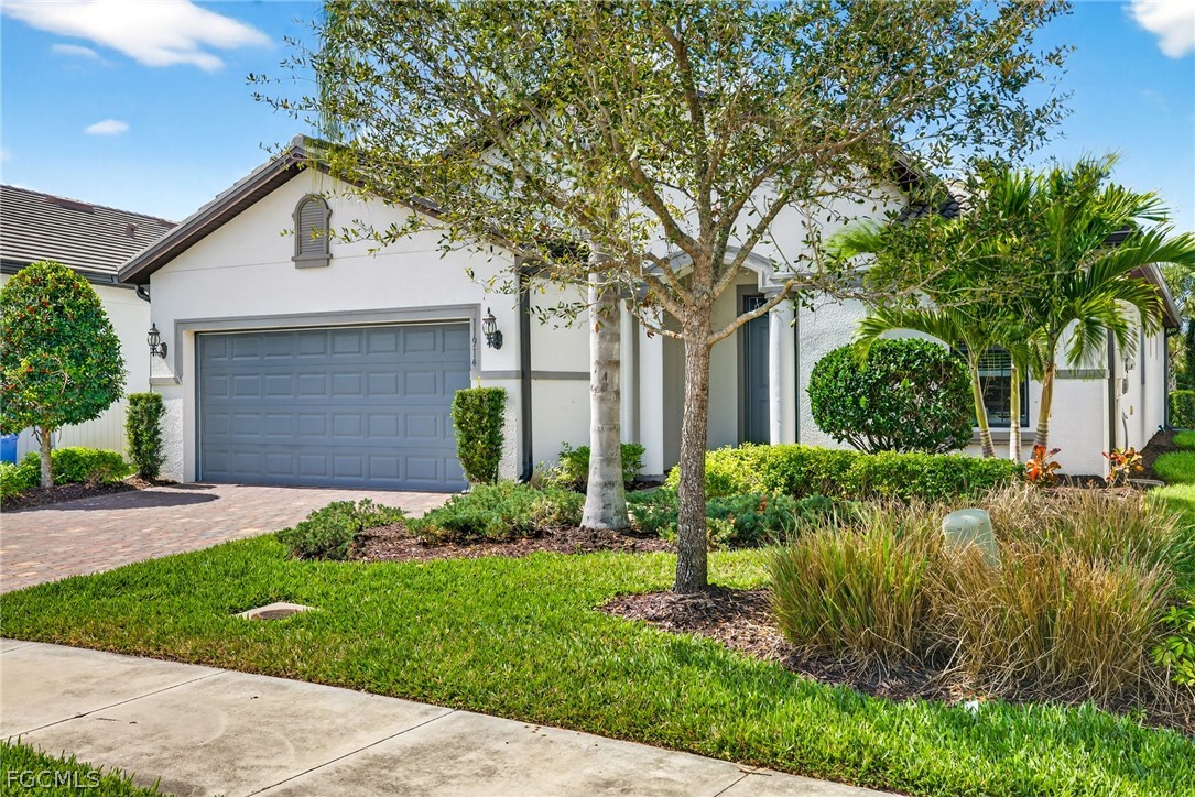 11914 Bourke Place Fort Myers, FL 33913 - Photo 35 of 49 a front view of a house with garden