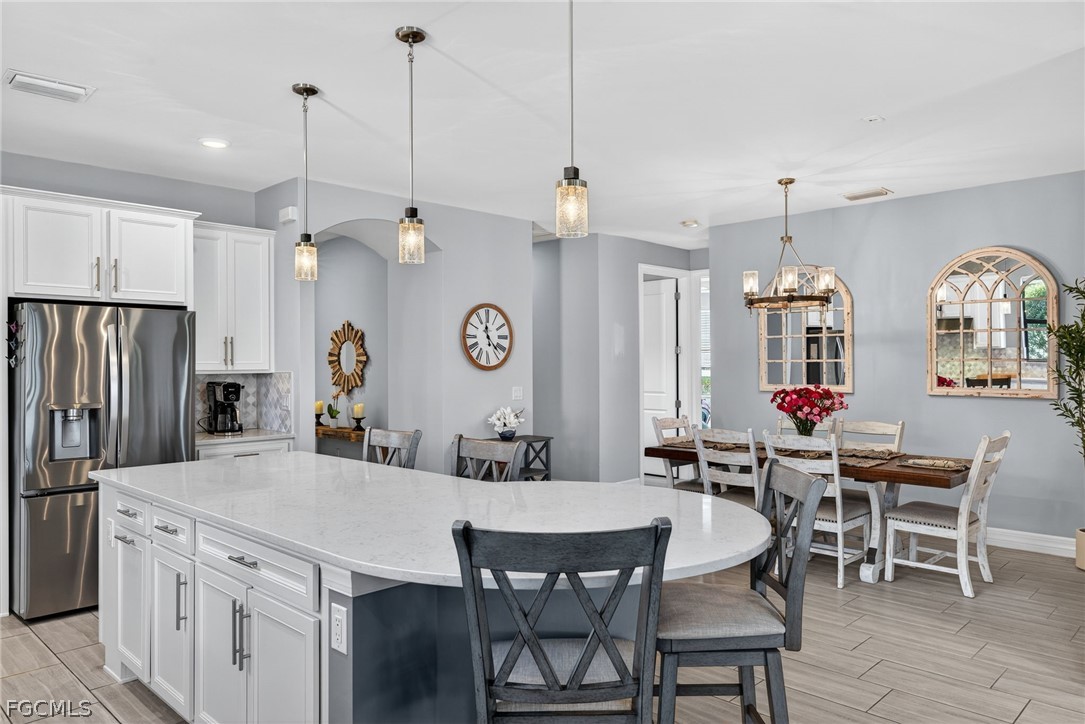11914 Bourke Place Fort Myers, FL 33913 - Photo 7 of 49 a large kitchen with a table and chairs