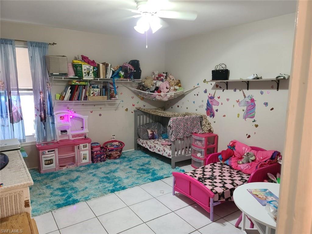 5563 17th Avenue Southwest Naples, FL 34116 - Photo 23 of 28 a bedroom with furniture and a baby crib