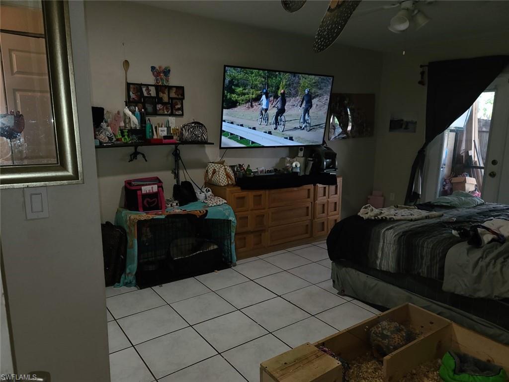5563 17th Avenue Southwest Naples, FL 34116 - Photo 26 of 28 a bed room with a bed and a television