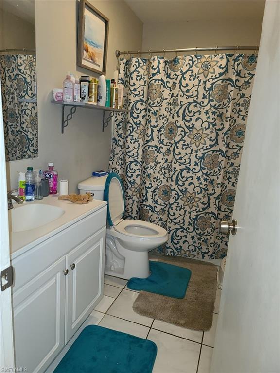 5563 17th Avenue Southwest Naples, FL 34116 - Photo 27 of 28 a bathroom with a toilet and a sink