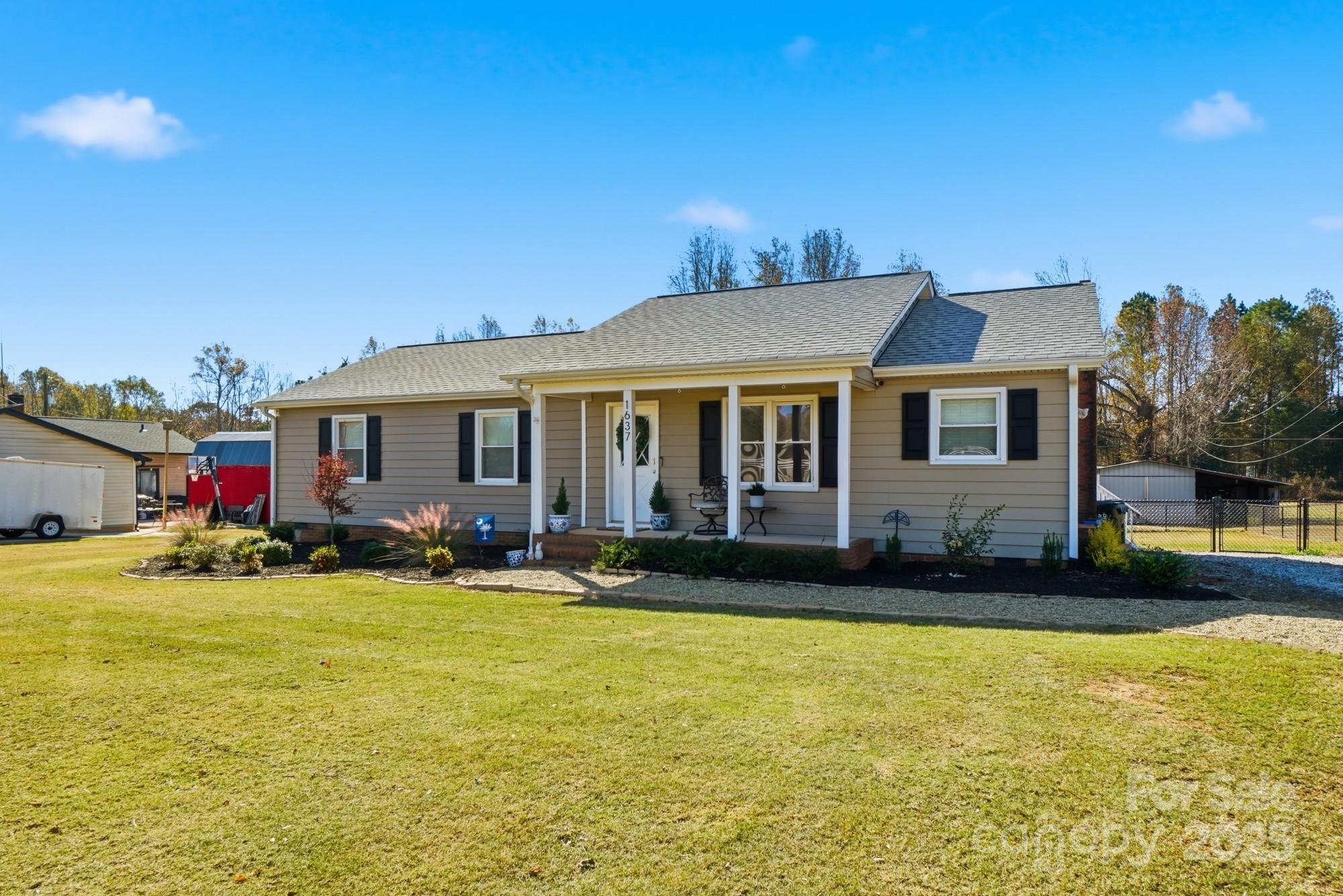 a front view of house with outdoor seating and yard