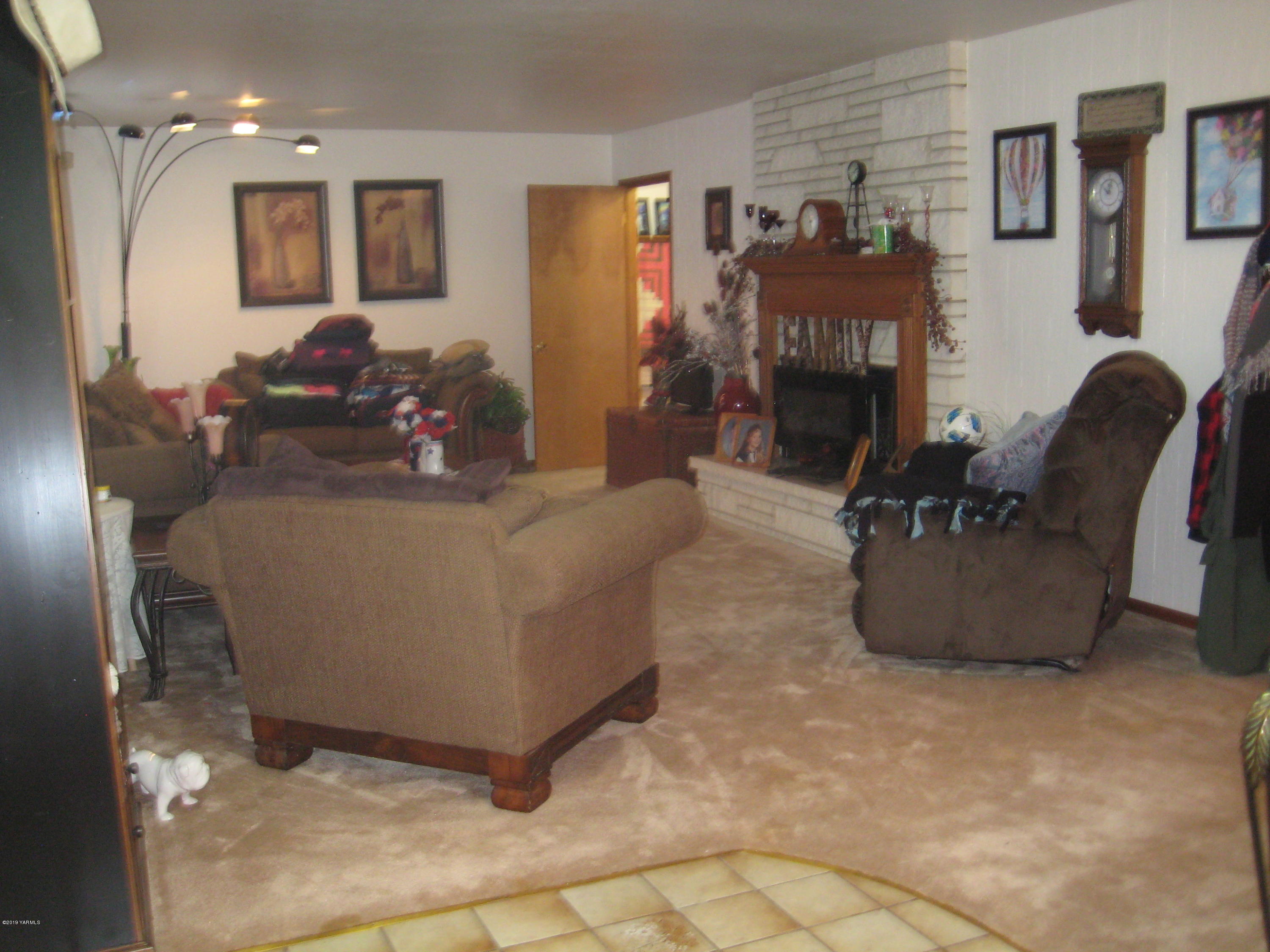 5900 Ashue Road Wapato, WA 98951 - Photo 14 of 60 a living room with furniture and a fireplace