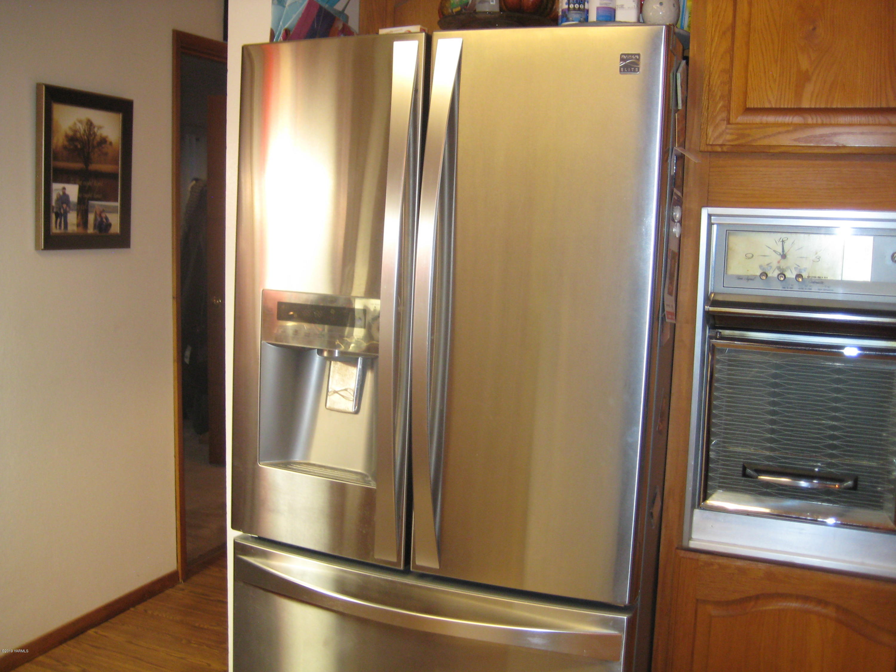 5900 Ashue Road Wapato, WA 98951 - Photo 21 of 60 a view of kitchen with stainless steel appliances wooden floor and chair
