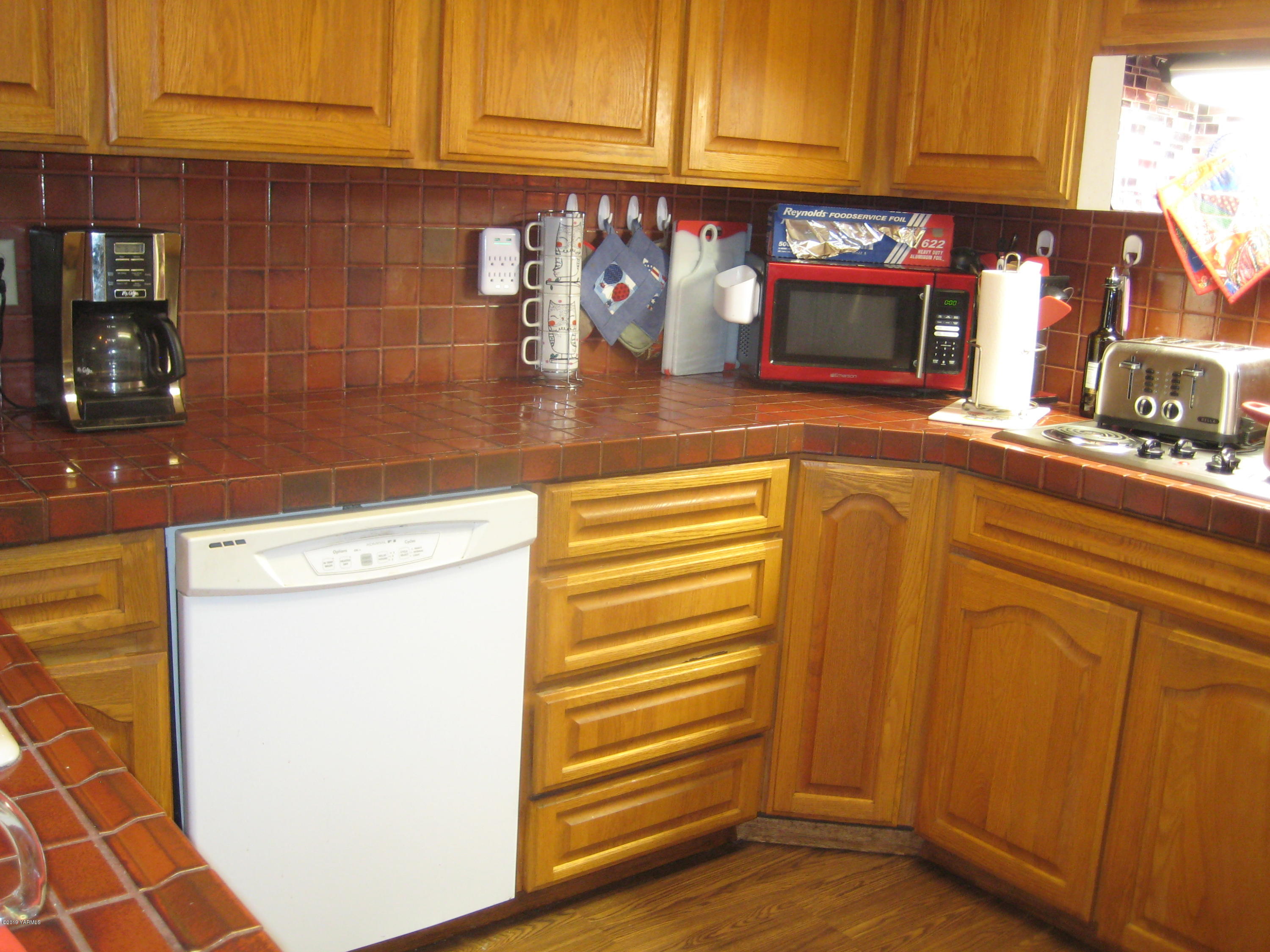 5900 Ashue Road Wapato, WA 98951 - Photo 23 of 60 a kitchen with a sink and cabinets