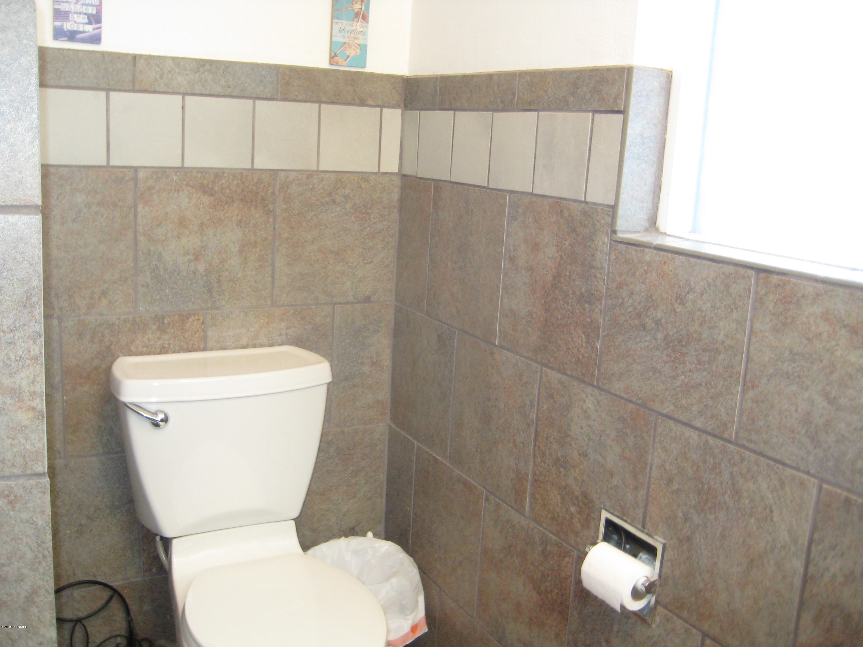 5900 Ashue Road Wapato, WA 98951 - Photo 39 of 60 a white toilet sitting next to a bathroom sink