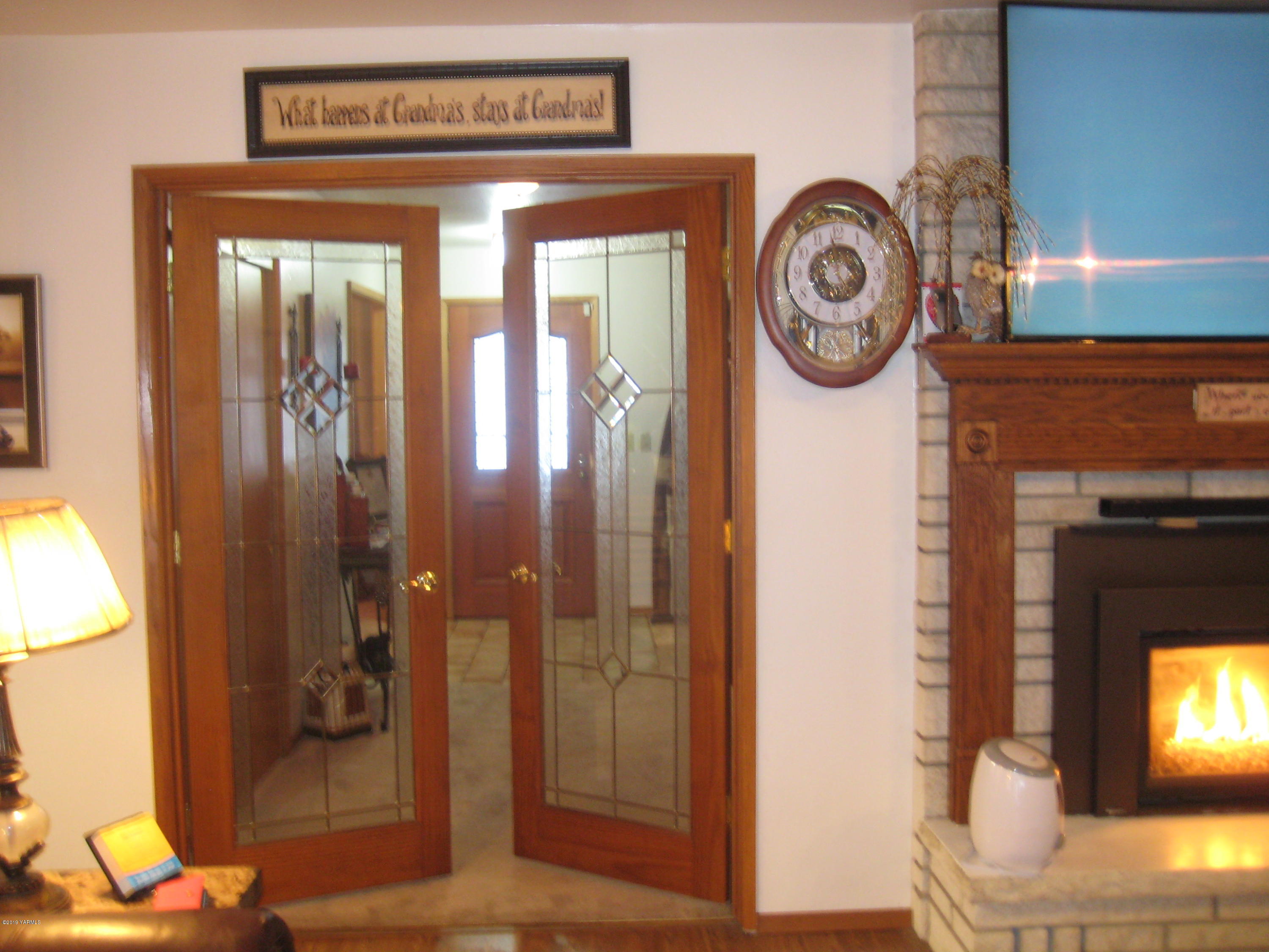 5900 Ashue Road Wapato, WA 98951 - Photo 10 of 60 a view of a hallway with entryway wooden floor and front door