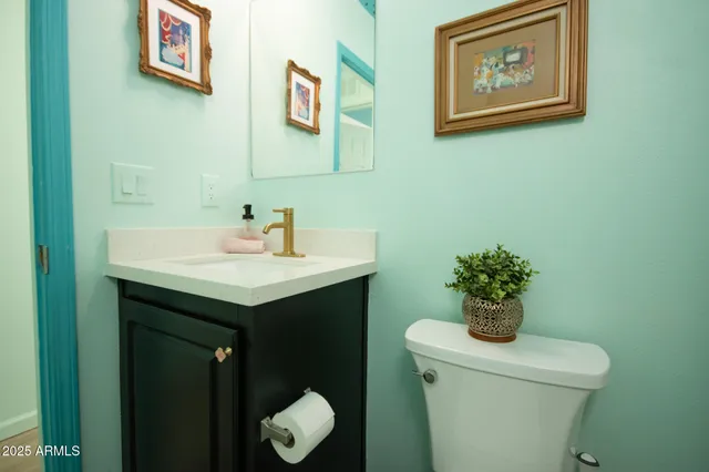 a bathroom with a toilet a sink and mirror
