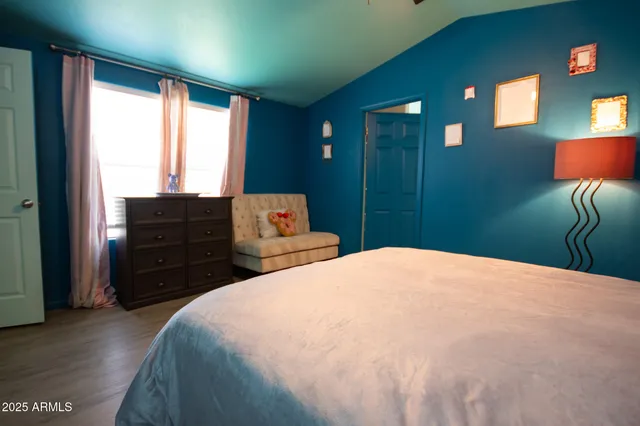 a bedroom with a bed and a window