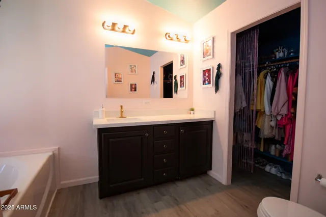 a bathroom with a sink vanity and a mirror