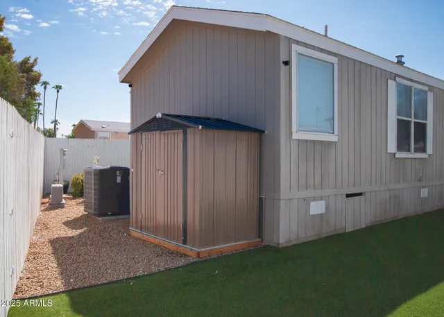 a backyard of a house with table and chairs
