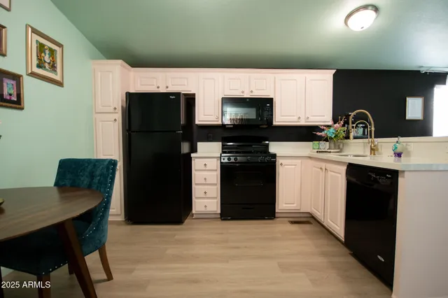 a kitchen with stainless steel appliances a stove refrigerator sink and cabinets