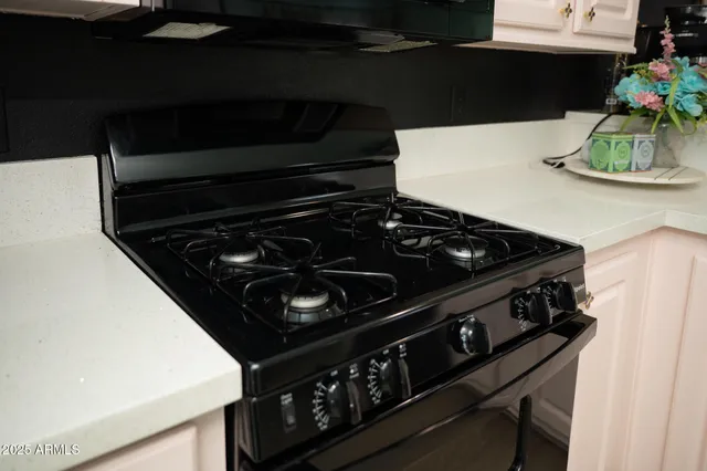 a stove top oven sitting inside of a kitchen