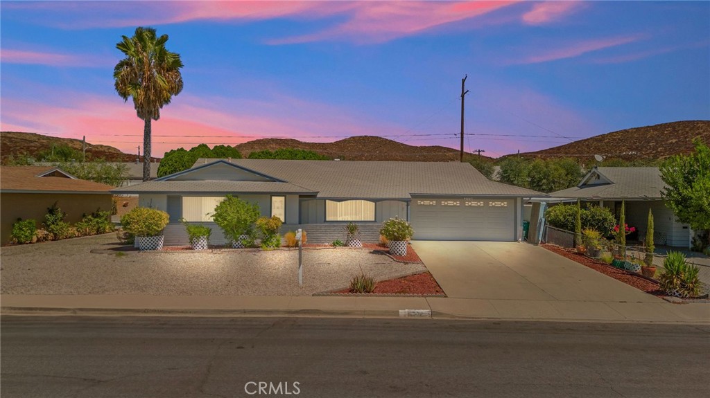 27370 Pinehurst Road Menifee, CA 92586 - Photo 1 of 1 a front view of a house with a garden and mountain view