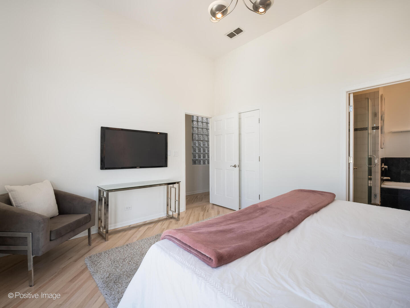 3053 North Clybourn Avenue, Unit 3 Chicago, IL 60618 - Photo 14 of 24 a bedroom with a bed and a television