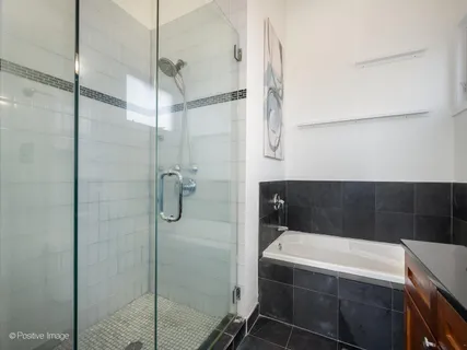 a bathroom with a tub and shower