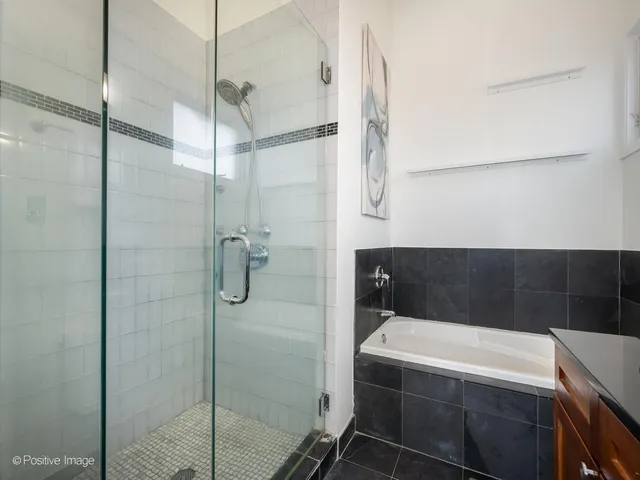 a bathroom with a tub and shower