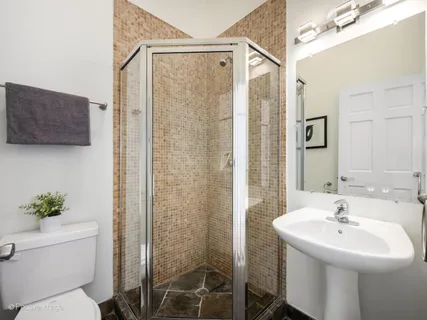 a bathroom with a sink toilet and shower