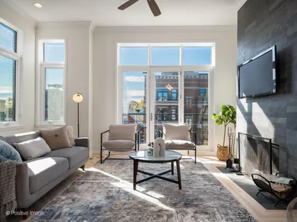 a living room with furniture a window and a flat screen tv