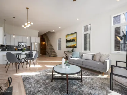 a living room with furniture a window and kitchen view