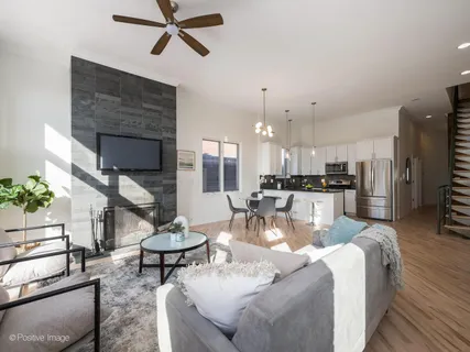 a living room with furniture and kitchen view