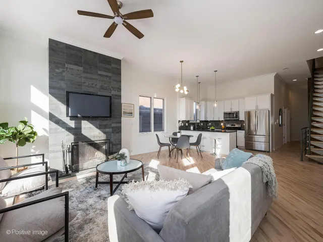 a living room with furniture and kitchen view