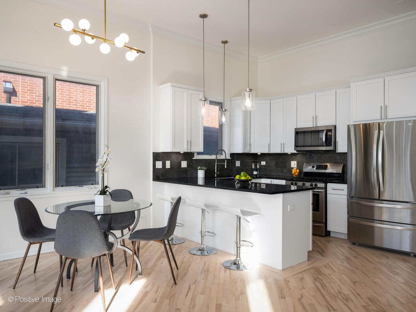 3053 North Clybourn Avenue, Unit 3 Chicago, IL 60618 - Photo 8 of 24 a kitchen with stainless steel appliances a dining table chairs stove and refrigerator