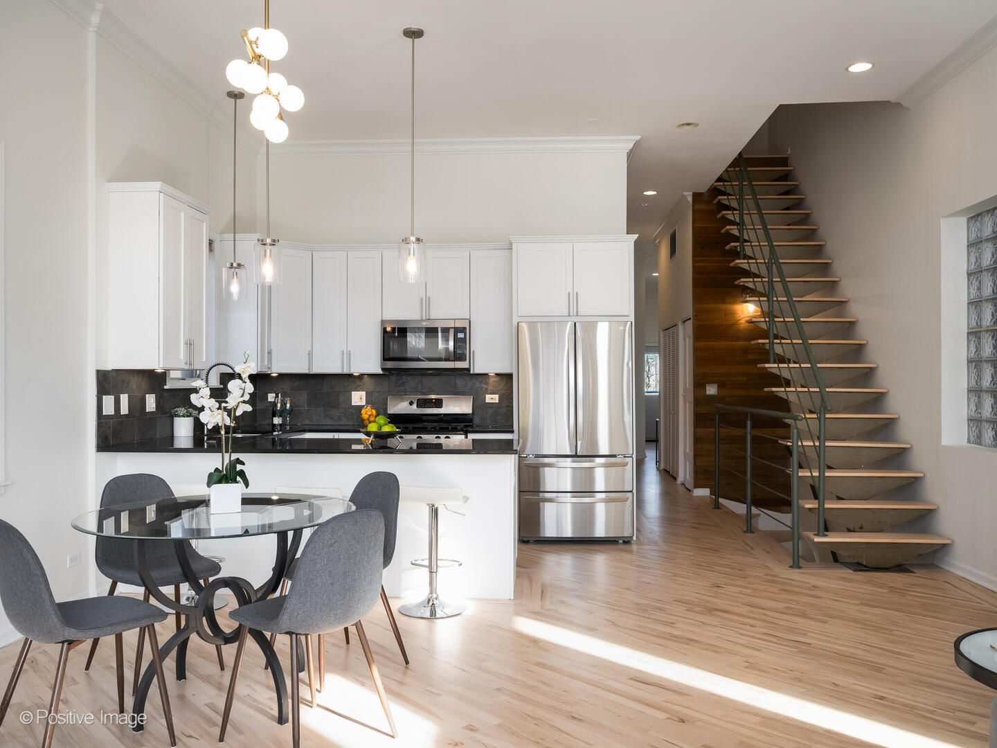 3053 North Clybourn Avenue, Unit 3 Chicago, IL 60618 - Photo 9 of 24 a kitchen with stainless steel appliances a dining table chairs and wooden floor