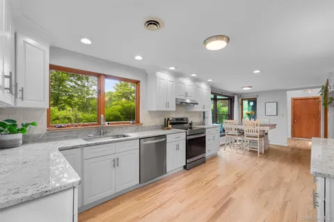 a kitchen with a sink and wooden floor