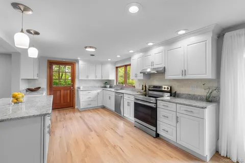 a kitchen with a sink cabinets and wooden floor