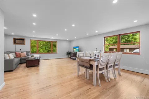 a view of a dining room with furniture window and wooden floor